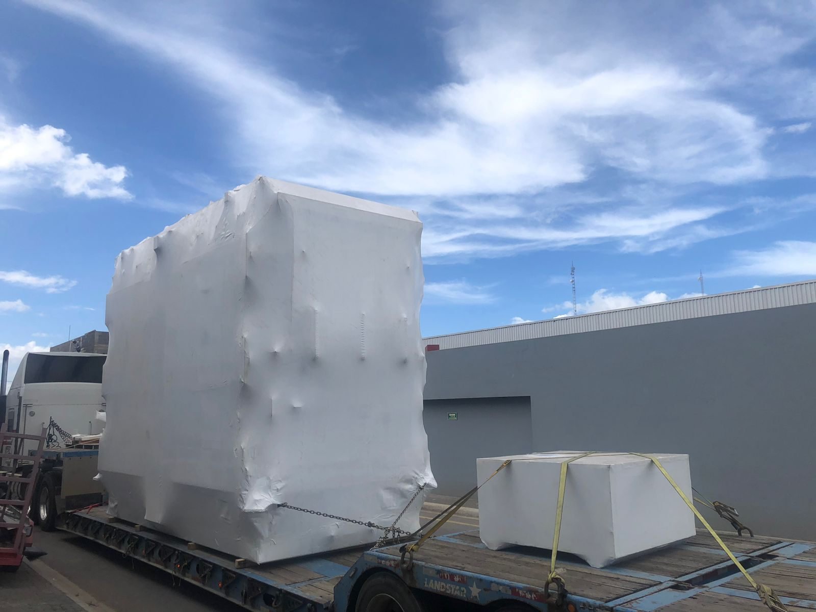 Transformer tank stretch-wrapped on a flatbed ready for export